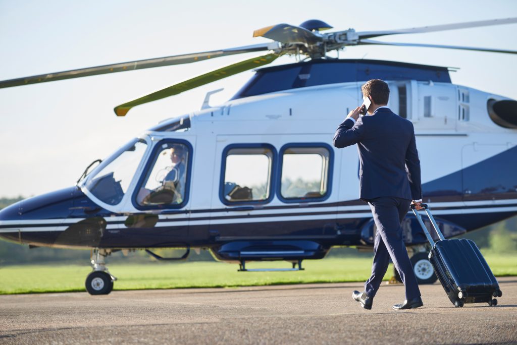 Business person boarding Helicopter private hire