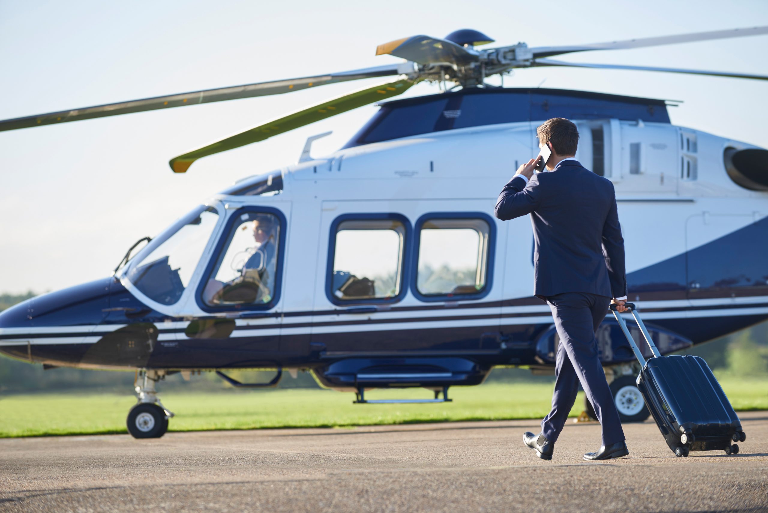 Business person boarding Helicopter private hire