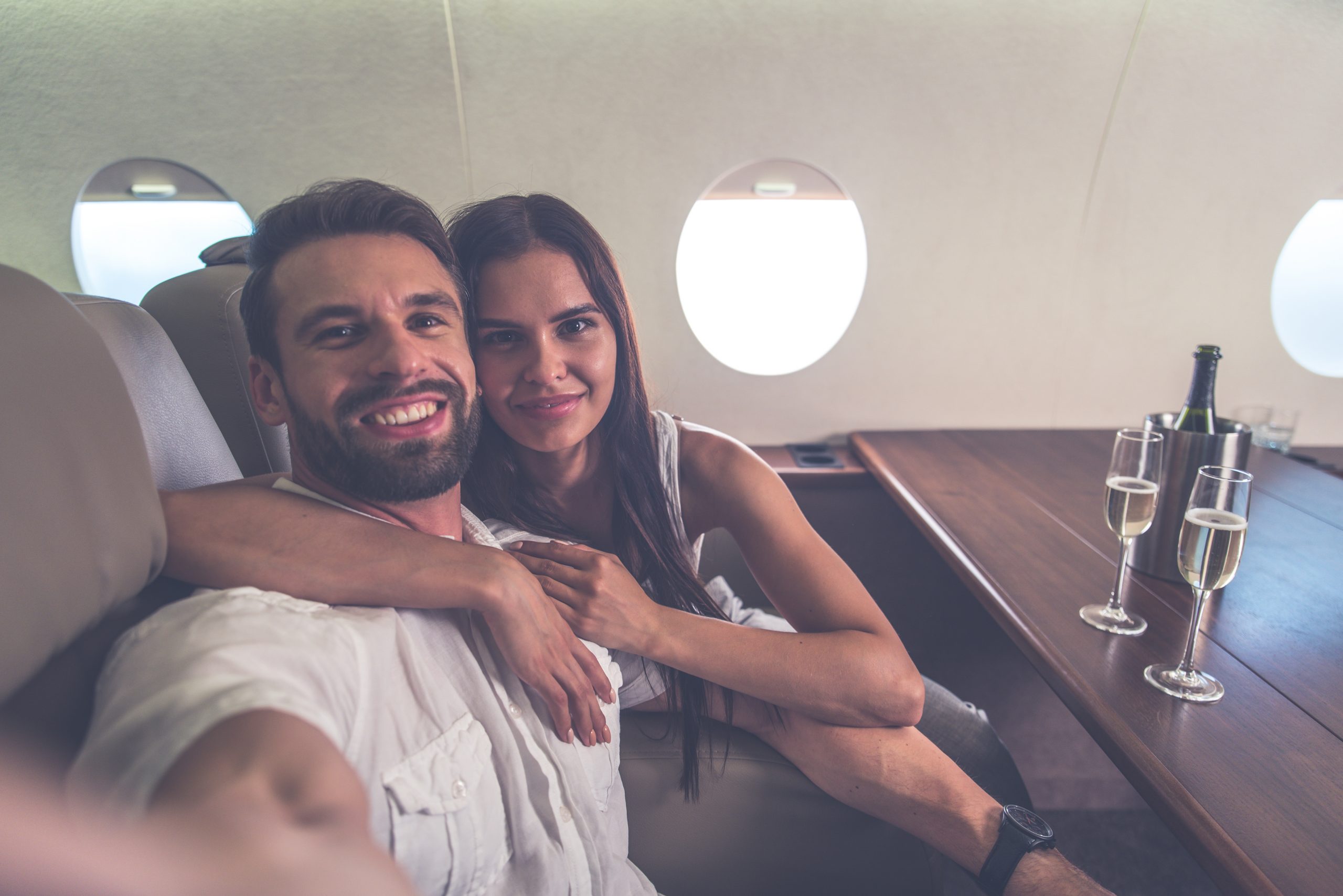 Happy couple selfie on board a private Jet